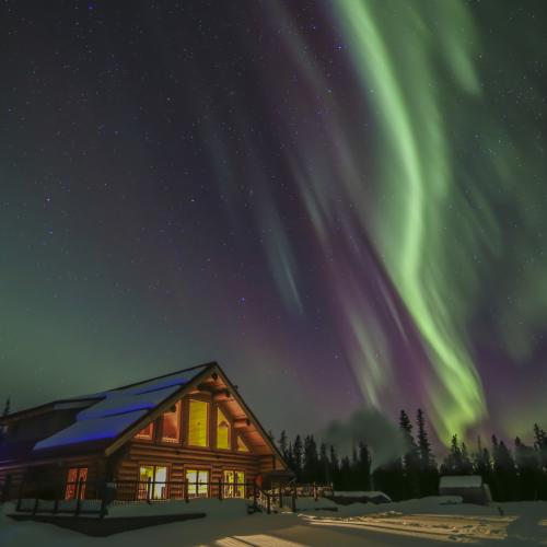 Aurora borealis shines above Northern Lights Resort and Spa