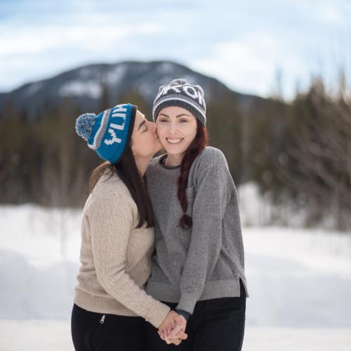 A cute couple share a kiss